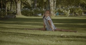 Girl Does Splits on Grassy Lawn Outdoors