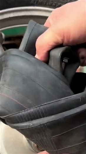 How to insert a tire into a motorbike by squeezing it. #shorts