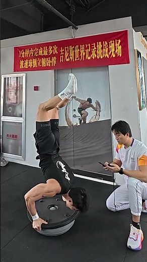 Chinese athlete performs incredible balancing handstand push ups