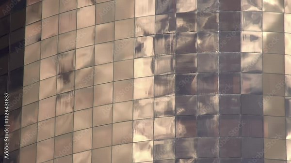 Reflections in Windows. Quickly running clouds reflected in the windows of a skyscraper. Time lapse