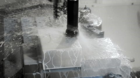 clip-4027588689-cnc-milling-machine-cutting-metal-block-coolant