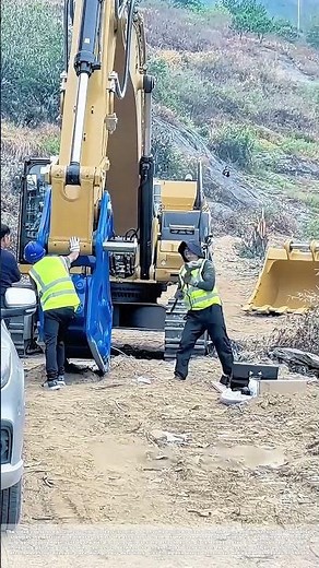 Striking the Pin: How Workers Secure an Excavator Attachment