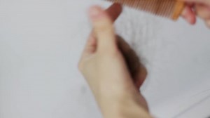 comb in hand with hair. Hair loss problem, hormonal failure, stress, diet, scalp and hair bulb disease