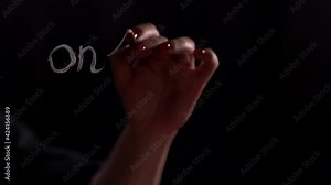 Handwritten message to make study or classes online. Text message 'Online education' on glass using brush and paint. Black background. 4k footage