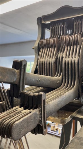 A manual dobby loom uses a chain of bars or lags each of which has pegs inserted to select the shafts to be moved. Here you can see the shafts being lifted. #DobbyLoom #TextileDesign #LoomWeaving #whitchurchsilkmill #loom #weaving #weave #woven | Whitchurch Silk Mill