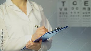 Female ophthalmologist examines patient, writes down diagnosis and treatment Stock Video