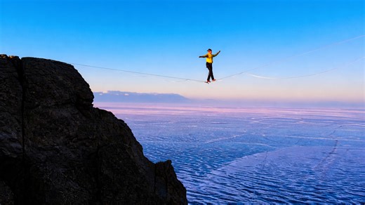 Extreme balance over a frozen expanse under clear skies
