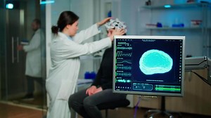 Medical researcher in neurological medicine preparing patient for examining brain functions using high tech and neurology tools for scientific research in technologically advanced lab office