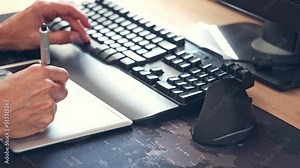 man hands working with computer keyboard mouse and graphic tablet