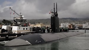 What happened when a submarine surfaced under a fishing ship