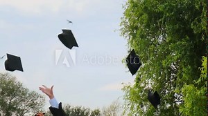 High school students graduate throwing graduation square academic cap bonnet into the sky in slow motion, education college ceremony in front of threes. Hands catching hats after finishing university