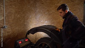 Balancing wheel with machine balancer at service.Balancing machines car wheels