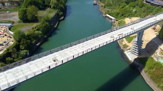 Check out the recent drone footage detailing the progress on the New Wear Footbridge 📹 Over the last 6 weeks 158 parapet panels have been positioned on the bridge The next steps will see the final parapet panels positioned, installation of the waterproofing layer, followed by the paving, deck furniture and internal bridge drainage. Connecting the north and south sides of the river, the footbridge is a key part of the 32-hectare Riverside Sunderland regeneration programme, that is transforming t