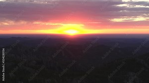 Spectacular aerial view over Custer State Park, South Dakota, as the sun hits the horizon and the sky burns pink and purple