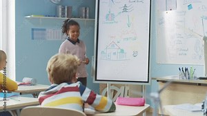 Elementary School Science Class: Cute Girl Uses Interactive Digital Whiteboard to Show to a Classroom full of Classmates how Renewable Energy Works. Science Class, Curious Kids Listening