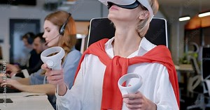 Caucasian blonde woman in VR glasses moving joysticks in air. Female in headset having virtual reality set. Futuristic call center. Augmented reality for support service. Gaming of future. Gamer.
