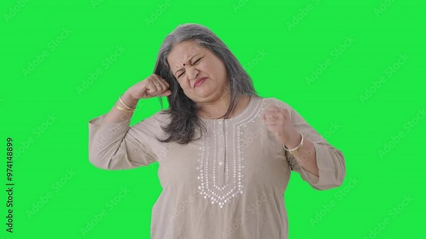 Sleepy and tired Indian old woman yawning Green screen