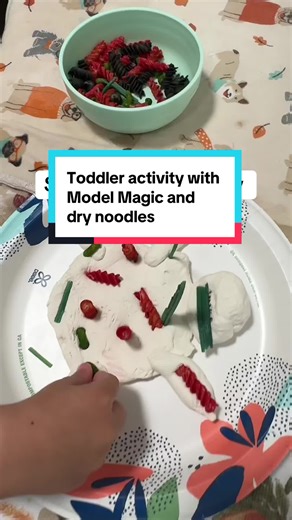 Such a fun and simple sensory toddler activity! All you need is Model Magic or Play-Doh and some dried noodles. You can even add googly eyes, buttons, and so much more. Your child will place all of the dried noodles onto the model magic and create their own piece of art. Always keep your eyes on your child so they don’t swallow any small objects. #toddleractivities #toddleractivitiesathome #sensoryactivities #sensoryplay #toddlercrafts