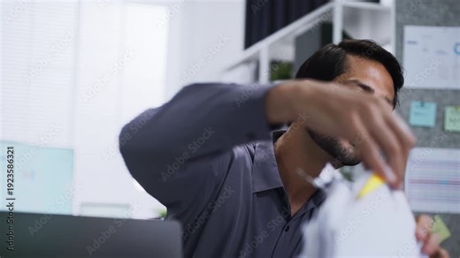 Tax season with Accounting and Tax Paperwork on a Laptop managed by a Businessman Working with stack of document
