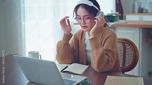 Upset asian woman looking at laptop screen, Sad female working laptop computer, Worried lady stress at freelance work at home workplace.