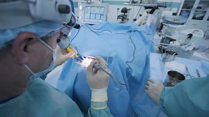 Operation of removing tonsils. tonsillectomy under deep anesthesia, using latest devices, cold plasma method, cuts swelling in throat, doctor works with new probe, medical headlamp, surgical loupes