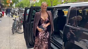 Molly Sims can't stop smiling as she models in front of her car