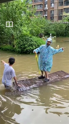 Residents ride floodwaters in northern China