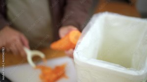 Ecology compost supply Kitchen waste sorting waste vegetable peels to recycle composter environmentally friendly. Man throws leftover fruit peel and vegetables reduce zero waste.