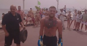 PRACTICE Conor McGregor works on his power shot at the beach in front of a crowd of people after being called out by former UFC champion Charles Oliveira