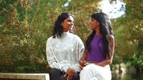 clip-3968386297-two-beautiful-young-indian-women-sitting-together