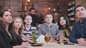 Sports fans watching a game in a bar - Free Stock Video