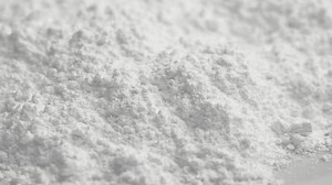Magnesium bisglycinate supplement white powder close up. Rotation