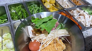 Korean foods served on a dining table. Perfect article, or any cooking contents. traditional hot pot combo, sweet garlic, and beef slices. It is very popular in sichuan