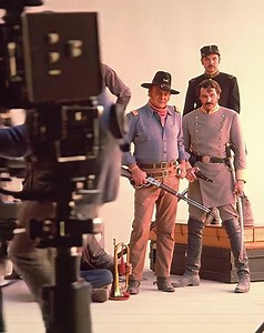 Behind the scenes of a promotional photo shoot for The Undefeated (1969). | The True Grit Man Forever