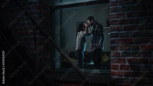 Couple Arguing and Fighting Horribly. Domestic Violence and Emotional abuse Scene, Stressed Woman and Aggressive Man Screaming at Each other in Dark Apartment. Dramatic Scene. Shot from Outdoors.