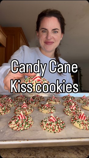 Candy cane kiss cookies! Episode 30 of my 45 days of Christmas cookie series! Ingredients: 10 tbsp unsalted butter 1 cup granulated sugar 1 egg 1 tsp vanilla extract 1/4 tsp peppermint extract 2 cups 1 tbsp all purpose flour 1 & 1/2 tsp baking powder 1/4 tsp salt 1/2 cup sprinkles (for rolling) 21-23 candy cane Hershey’s kisses unwrapped How to: In a mixing bowl combine butter and sugar and mix. Add in egg and extracts and mix until well combined. In a separate bowl combine all purpose flour, ba