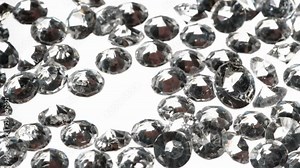 Manual Sorting of Cut Diamonds. The camera moves slowly along the light table on which diamonds are scattered. An expert selects large specimens with tweezers