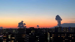 Explosions and thick smoke rise above Tehran's evening skyline