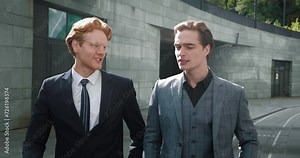 Two men in suit's walking dialogue focused on collaborative work Walk is metaphor for collaborative work journey. Synchronization of steps echoes harmony of their collaborative work.