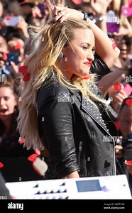 Wearing a black sequenced mini dress with a leather jacket and black ankle boots, singer Demi Lovato performs live the 2012 MTV Video Music Awards held at the Staples Center in Los Angeles, CA. 6th September 2012 Stock Photo - Alamy