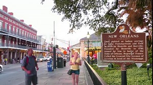 Timelapse of New Orleans Historic Signage in front of the famous Cafe Du Monde busy with tourists exploring the sights.