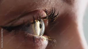 Close-up of a young woman having her vision tested on an ophthalmology diagnostic vision testing equipment. Professional ophthalmological apparatus.