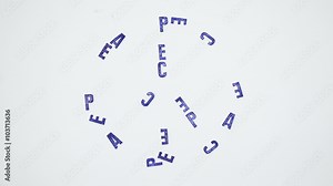 PEACE symbol made from blue letters on white paper background. Stop motion animation.