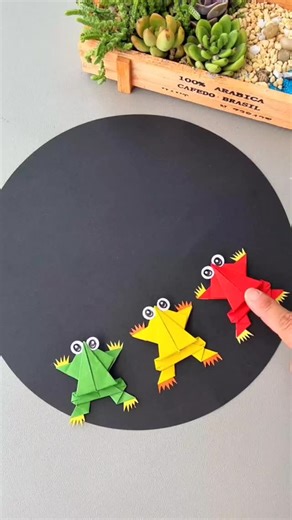 Simple and Easy Drawing Ideas on Instagram: "Jump into Fun with a Paper Frog! 🐸✨ With just a few clever folds, you can bring this little frog to life! Start by folding the bottom left and right corners, then repeat the same on top. Fold the middle inward from both sides, then lift the top sides up and down. Do the same for the bottom. Now, fold the corners into neat little triangles and bend the center twice—this gives your frog its bouncy legs! Give it a gentle press, and watch it leap forward