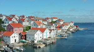 Flight over houses in Sweden on island. Coastal community luxurious area