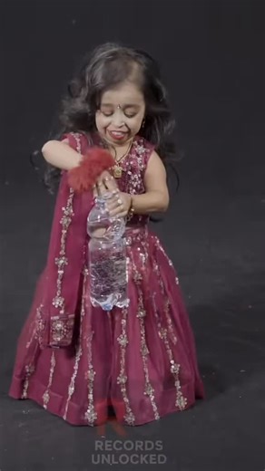 Records Unlocked on Instagram: "She Is The World’s SHORTEST Woman! Meet Jyoti Amge from India, officially the world’s shortest living woman, as verified by Guinness World Records. 🤯 She stands at just 62.8 centimeters (2 feet 0.7 inches) tall. Her unique record is due to a form of dwarfism called Achondroplasia. Despite her size, Jyoti has embraced her fame and has even pursued an acting career in television. Her story proves that size is no limit to success! Don’t forget to hit follow for more
