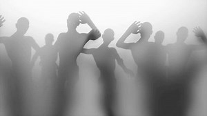 A horror style shot of a zombie army with hand moving out of blur and hitting the glass. Someone wants to go through a thick glass wall and flap arms