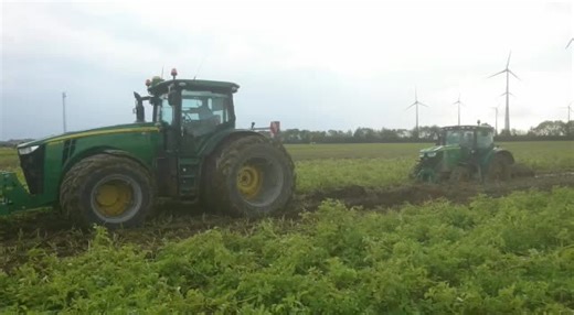 Large Green Tractors Working in the Field