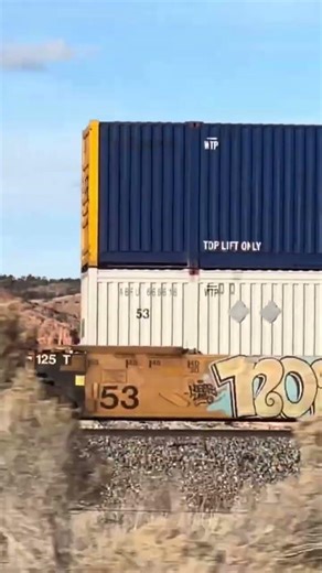 Being passed by intermodal railroad shipping container train