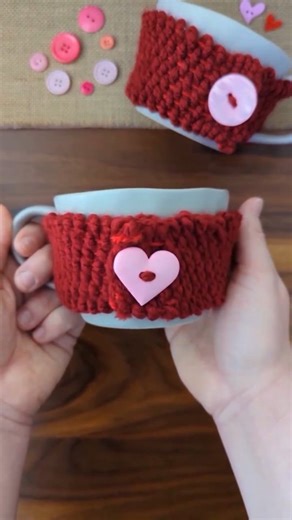 Jen Buchheit on Instagram: "Cardboard Loom Woven Mug Cozy ❤️ Using cardboard and yarn to create this cute DIY Valentine's Day mug! I measured around the mug to find out what length of cloth needed, then cut a piece of cardboard to that size. I cut notches around the top and bottom of the cardboard and wrapped yarn around the cardboard and behind the tabs to create a loom. I cut a popsicle stick on one end, just enough to split the wood, to hold the yarn for weaving. We used the popsicle stick to